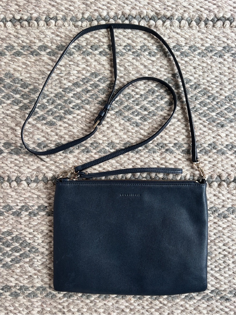 Coccinelle navy leather crossbody purse clutch bag with removable strap.